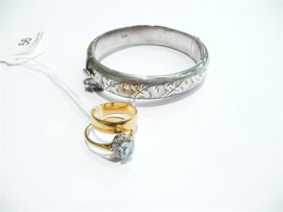 Lot 56 - A 22 carat gold band ring, a cluster ring and a silver bangle
