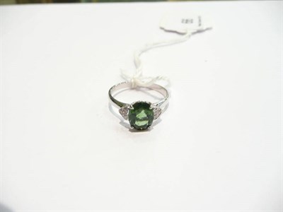 Lot 66 - An 18 carat white gold green tourmaline and diamond cluster ring