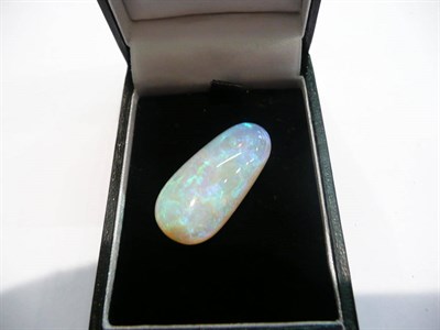 Lot 80 - A loose oval cabochon opal, weighing approximately 23.00 carats, a light grey background with a...