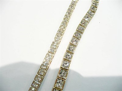 Lot 90 - Gold and zirconium line bracelet and a gilt metal line bracelet