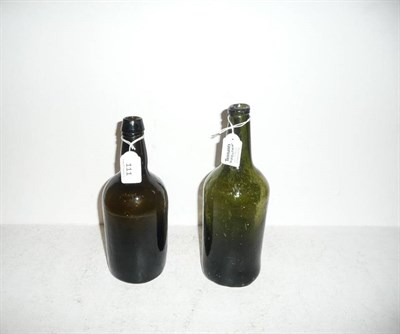 Lot 111 - A wine bottle, three-part Ricketts mould, circa 1825, 24cm high; and an English wine bottle,...