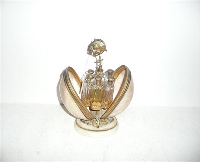 Lot 124 - Shell scent bottle stand with six bottles