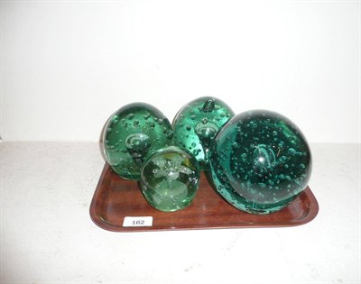 Lot 162 - Four 19th century green glass paperweights