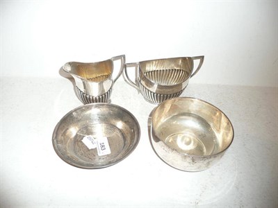 Lot 183 - Silver sugar basin and cream jug, Sheffield 1924, a silver circular bowl and a silver dish (4)