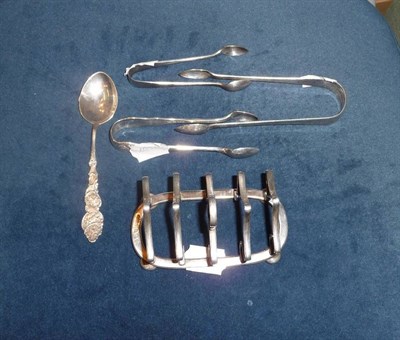 Lot 214 - A silver toast rack, Birmingham 1910, a pair of silver tongs, London 19th century, another...