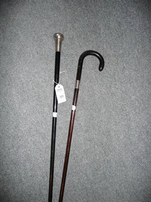 Lot 223 - Silver-mounted walking cane and a stick