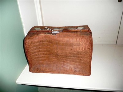 Lot 397 - A leather travel bag with silver topped bottles