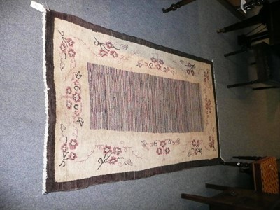 Lot 472 - An Oriental rug with shaded polychrome panel