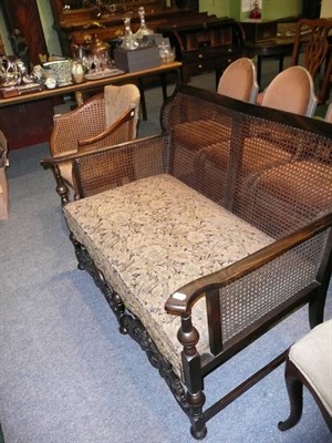 Lot 542 - An early 20th century beech-framed bergere settee together with a 1920's tub-shaped bergere