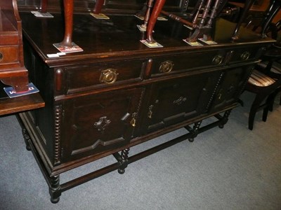 Lot 584 - Oak sideboard, oak four drawer chest and a draw leaf dining table