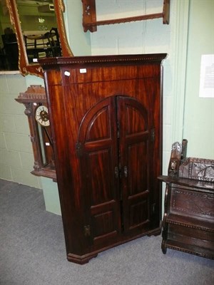 Lot 593 - George III and later mahogany corner cupboard