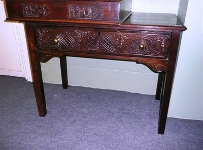 Lot 607 - An 18th century oak and later carved side table