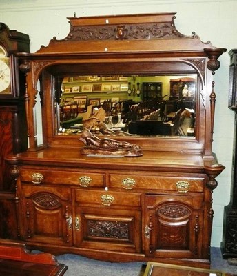 Lot 619 - A large oak mirror back sideboard