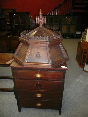 Lot 656 - A carved oak font cover, oak hymn book rest and a stained wood chest