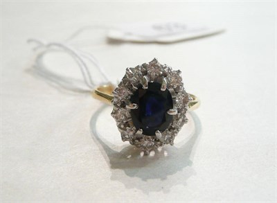 Lot 63 - A sapphire and diamond cluster ring
