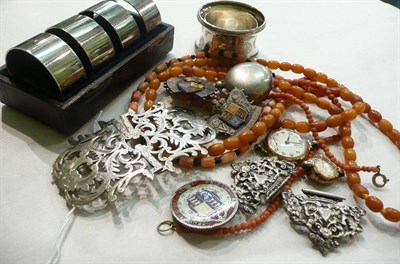Lot 76 - Assorted silver jubilee brooches, napkin rings, amber, coral and a nurses buckle and a gold...