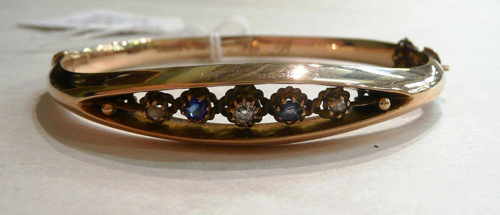 Lot 102 - A 9ct gold sapphire and diamond bangle