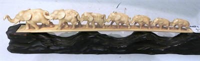 Lot 127 - Circa 1940's ivorine carving on stand of elephants