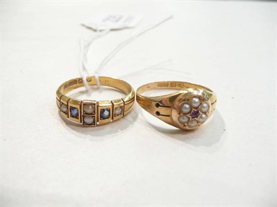 Lot 225 - A 15ct gold sapphire and seed pearl ring and a 15ct gold ruby and seed pearl cluster ring