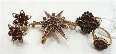 Lot 230 - A garnet star brooch, a pair of earrings and two cluster rings (one stone missing)