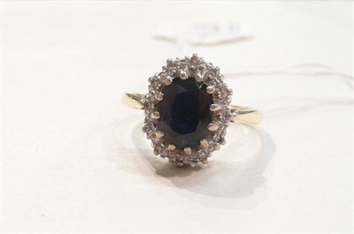 Lot 235 - An 18ct gold sapphire and diamond cluster ring