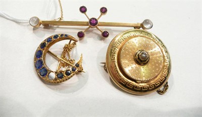 Lot 247 - A crescent brooch (one stone missing), a garnet and moonstone bar brooch and a Victorian disc...