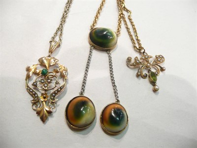 Lot 248 - A peridot and seed pearl pendant on chain, another, a necklace set with shell and a locket