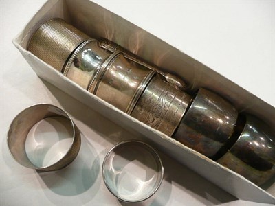 Lot 251 - Eight silver napkin rings and a pair of tongs