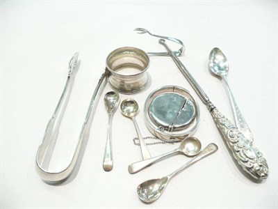 Lot 386 - A quantity of silver items including a vesta case, bangles, nips, spoons, button hooks, napkin...