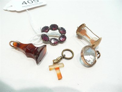 Lot 405 - A Georgian brooch, a fob, a miniature hourglass, a cross and a charm