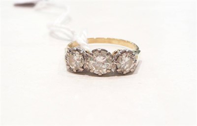 Lot 411 - A diamond three stone ring, the graduated round brilliant cut diamonds in a white claw setting to a