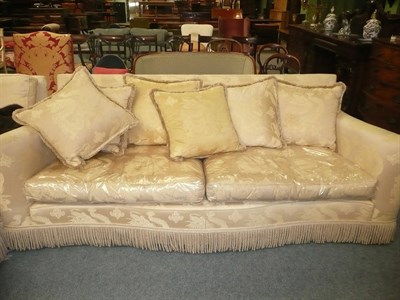 Lot 653 - A large cream three seater settee, chair and a foot stool