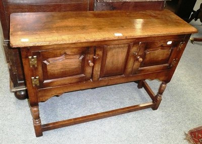 Lot 677 - An oak small two door dresser base in Titchmarsh & Goodwin style