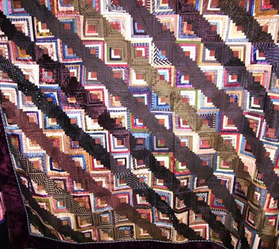 Lot 1031 - Victorian Log Cabin Patterned Quilt with red velvet and braided borders.