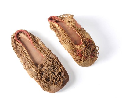 Lot 1134 - Two Similar 19th Century Children's Straw Work Shoes with a leather sole, faded pink silk...