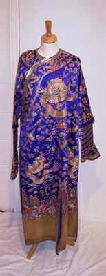 Lot 1137 - A Chinese Mandarin Robe of purple silk, heavily embroidered in gilt threads depicting the four...