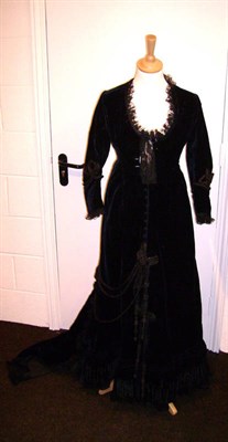 Lot 1140 - 19th Century Midnight Blue Velvet Dress with buttons to the front, black braid trimming, lace...