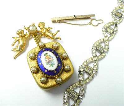 Lot 1143 - A Musical Pendant Brooch, by Michael Maer for Christian Dior, a cherub motif  suspends an enamelled