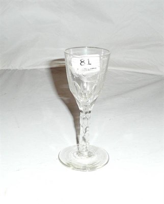 Lot 81 - An 18th Century wine glass with bird and foliate cut and etched bowl, on a facet cut stem.