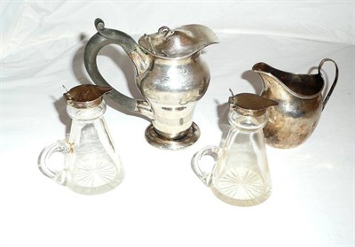 Lot 86 - Two silver mounted glass whisky tots, Georgian silver cream jug and a small silver lidded jug (4)