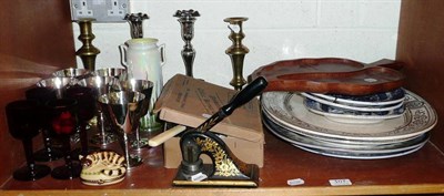 Lot 107 - Two shelves including Victorian pottery plates, pair of plated candlesticks, plated goblets,...