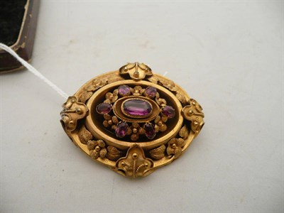 Lot 118 - A Victorian amethyst brooch in a textured foliate frame (a.f.)