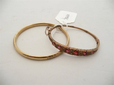 Lot 143 - A 9 carat gold bangle and a stone set bangle (stones missing)