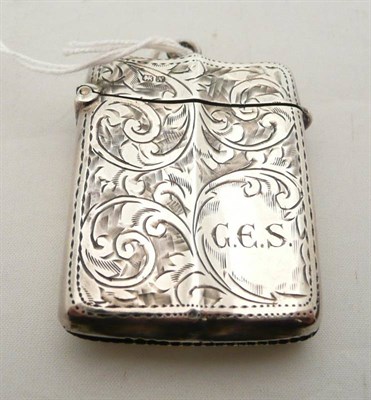 Lot 146 - A silver vesta case with shaped body and scrolling decoration