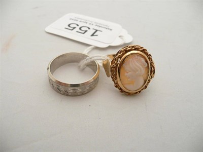 Lot 155 - A cameo ring stamped '750' and a white patterned band ring stamped '750', 9.7g approx. (2)