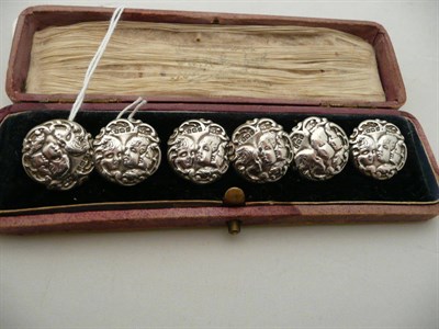 Lot 172 - A cased set of six silver buttons embossed with cherubs, Birmingham 1901