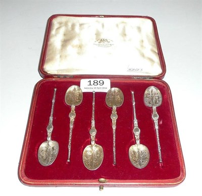 Lot 189 - A cased set of six silver coffee spoons with chased decoration.