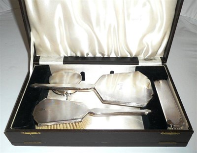 Lot 208 - An Art Deco silver backed dressing table set, cased, and a jewellery casket