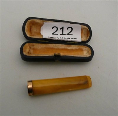 Lot 212 - A George V amber cheroot holder with 9 carat gold mount, cased.