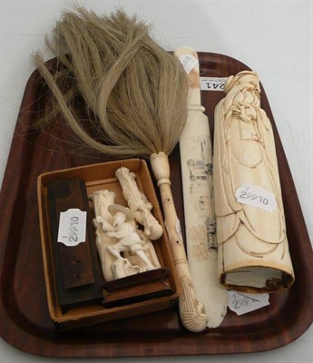 Lot 241 - A Japanese one piece ivory figure of a scribe, a set of three small ivory figures on a hardwood...